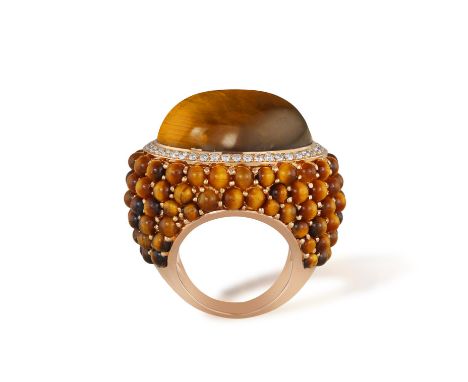 INBAR: A TIGER'S EYE AND DIAMOND COCKTAIL RINGOf bombé design, centring an oval-shaped tiger's eye cabochon, within a brillia