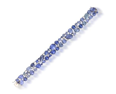 A SAPPHIRE AND DIAMOND BRACELETOf openwork articulated design, set throughout with fancy rose-cut sapphires of varied blue hu