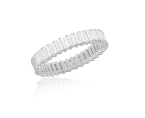 A DIAMOND ETERNITY RINGComposed of a continuous row of baguette-cut diamonds within claw-setting, mounted in 18K white gold, 
