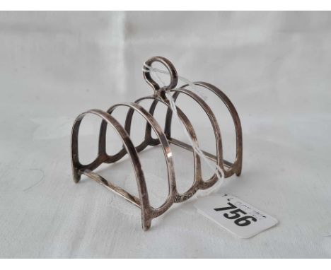 Small toast rack with ring handle. 3 inch high. 1929. Birmingham. 41 gms