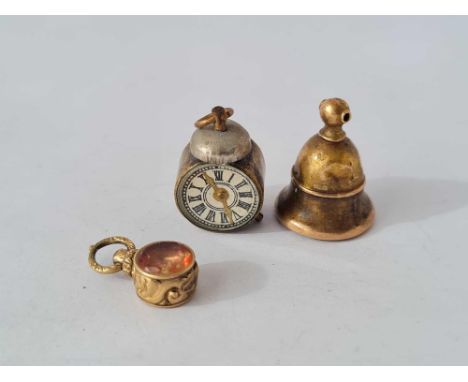 Three assorted charms including an alarm clock example