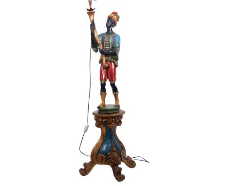 Mid-century painted plaster "blackamoor" standard lamp in the form of a figure standing and clutching a four-branch candelabr