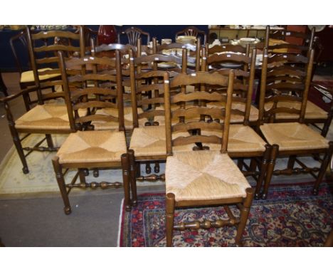 Set of ten matched Lancashire style ladder back rush seat dining chairs comprises two carvers and eight single chairs