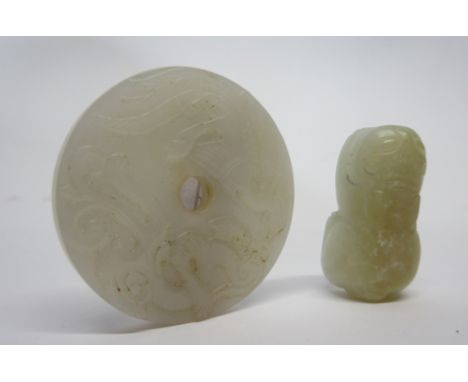 Chinese jade model of a cat, the white jade with russet occlusions, together with a circular disc carved with birds (2)