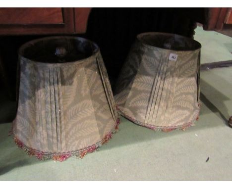 A pair of silk lamp shades with porcelain white and gilt finials, and two others 