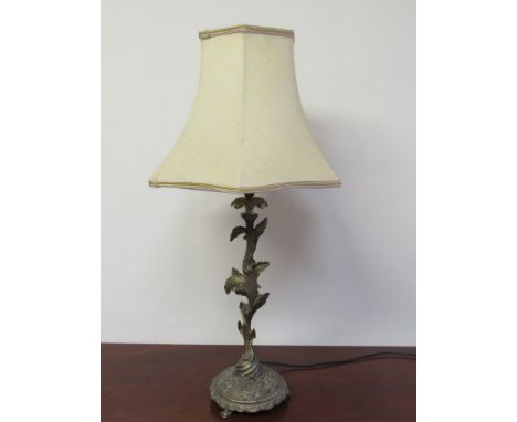 A brass table lamp of foliate design, cream shade 