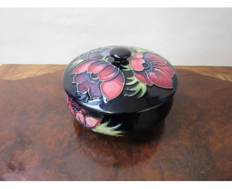 A Walter Moorcroft 'Anemone' design lidded trinket pot, 13cm diameter 
