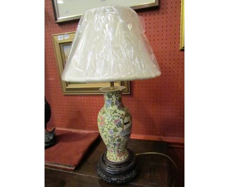 An Oriental butterfly and vine design table lamp with pleated shade, on carved wooden base, 56cm tall 