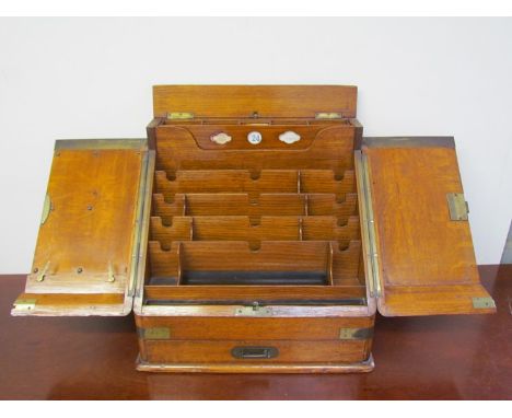 An early 20th Century light oak stationary desk tidy with double doors revealing compartmental letter/paper tidy, perpetual c