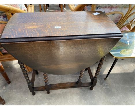 AN EARLY 20TH CENTURY OVAL OAK GATE LEG TABLE ON BARLEY TWIST LEGS, 42" X 29" OPENED