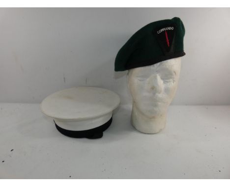 A GREEN BERET WITH COMMANDO BADGE AND A ROYAL NAVY HAT
