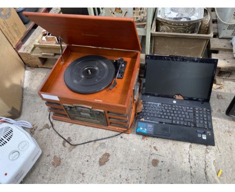 A RETRO STYLE RECORD PLAYER AND A LEPTOP