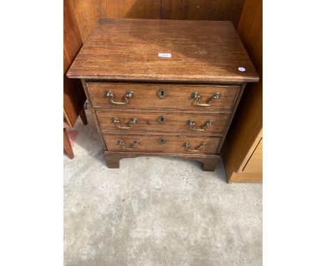 A MINIATURE MAHOGANY 19TH CENTURY STYLE CHEST OF THREE DRAWERS ON BRACKET FEET, 21" WIDE