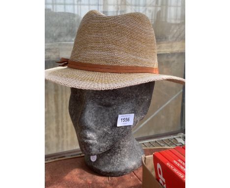 A POLYSTYRENE HAT STAND AND HAT