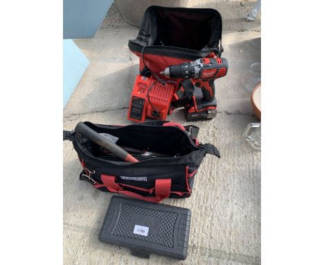 A MILWAUKEE BATTERY DRILL WITH CHARGER, A SOCKET SET AND A TOOL BAG CONTAINING HAND TOOLS ETC