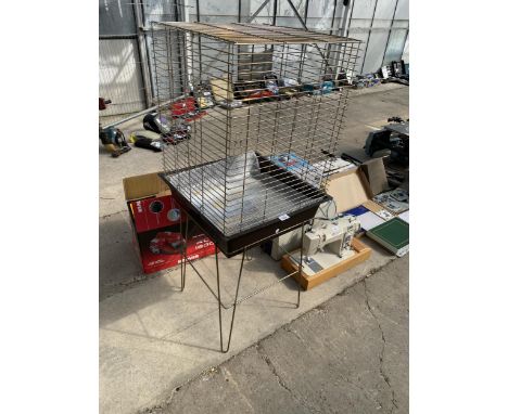 A METAL BUDGIE CAGE WITH STAND