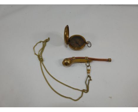 A BRASS AND COPPER BOSUNS WHISTLE AND A BRASS CASED COMPASS