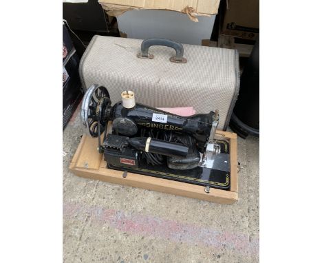 A SINGER ELECTRIC SEWING MACHINE WITH FOOT PEDAL AND CARRY CASE