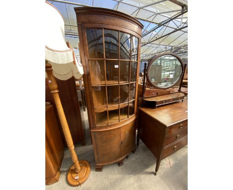A WALNUT BOW FRONTED WARING AND GILLOW (LANCASTER) CORNER CUPBOARD WITH GLAZED UPPER PORTION