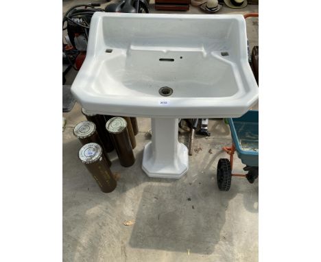 A WHITE CERAMIC PEDESTAL SINK UNIT