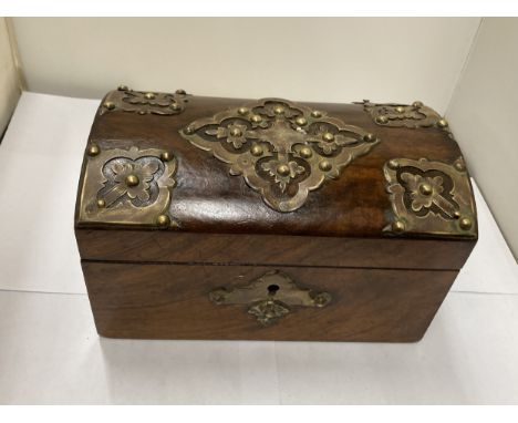 A WALNUT DOMED TOP TEA CADDY WITH BRASS DECORATION