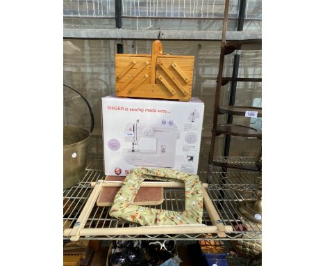 A SINGER ELECTRIC SEWING MACHINE, A CONCERTINA SEWING BOX AND A CROSS STITCH FRAME