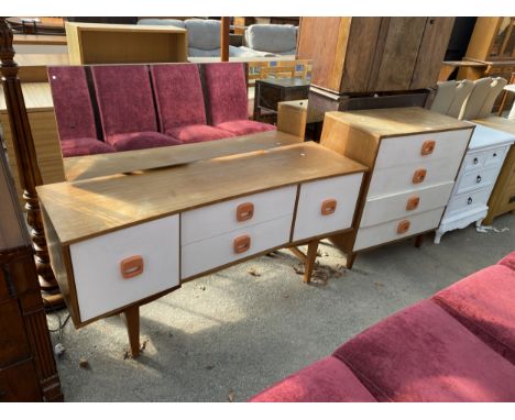 A RETRO TEAK AND WHITE INVERTED BOW FRONT DRESSING TABLE AND MATCHING CHEST OF FOUR DRAWERS, BOTH WITH ORANGE HANDLES