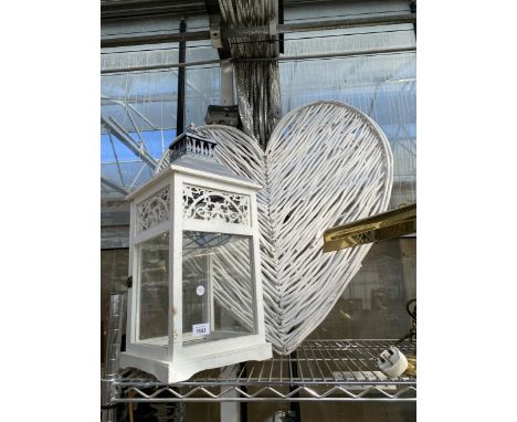 A LARGE WICKER HEART AND A WOODEN CANDLE LANTERN
