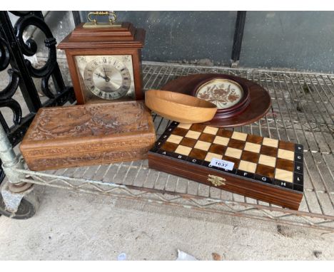AN ASSORTMENT OF TREEN ITEMS TO INCLUDE A MANTLE CLOCK, BOWLS AND A CHESS SET ETC
