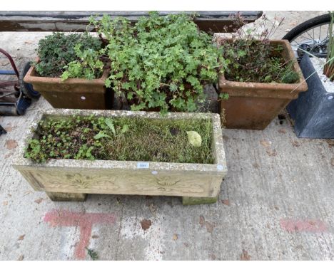 THREE TERRACOTTA PLANT POTS AND A CONCRETE TROUGH PLANTER