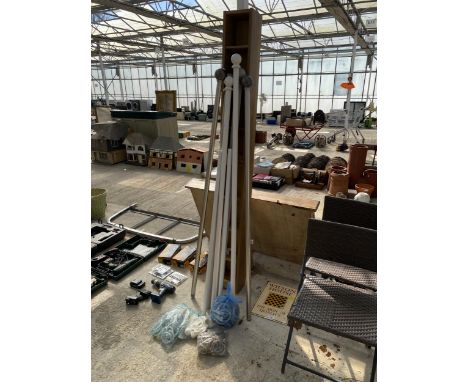 AN ASSORTMENT OF CURTAIN POLES AND A CD RACK