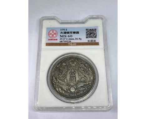 A CHINESE SILVER DOLLAR PROOF COIN IN A PRESENTATION CAPSULE