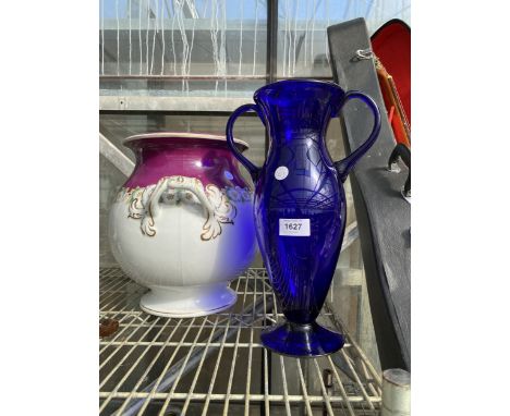 A LARGE CERAMIC TWIN HANDLE PLANTER AND A BLUE GLASS VASE