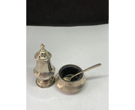 A STERLING SILVER CRUET AND SPOON SET