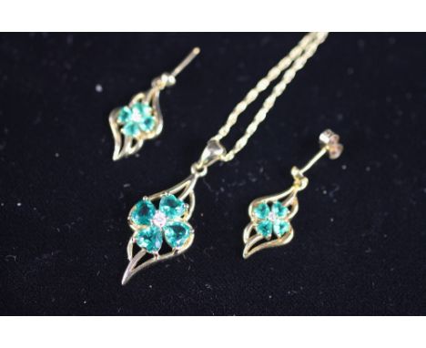 An emerald and diamond set pendant and matching drop earrings, all set in 9ct yellow gold, each designed as a central floral 