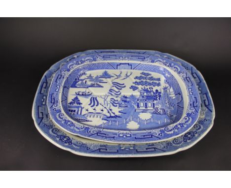 An early 19th century pearl ware Willow pattern blue and white meat plate; and a smaller meat plate with tree and well, 56cm 