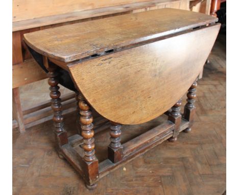 An early 18th century oak gate leg table, on turned and block legs, 63cm x 85cm