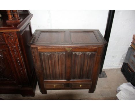 A 1920's oak mule chest, with linen fold panel front and two drawers on stile feet, 78cm x 83cm x 44cm
