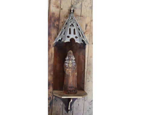 A 20th century carved, gilt and stained wood figure of a saint, on shelf with pierced canopy, 115cm