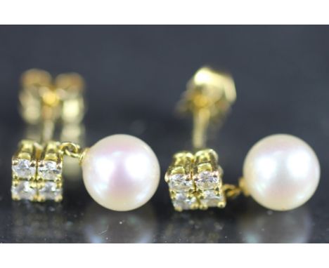 A pair of diamond and pearl earrings set in 18ct yellow gold, designed as a cluster of four diamonds, suspending an untested 