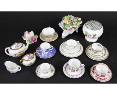 A Hammersley bone china three piece miniature tea set, decorated with flowers, with various other miniature cups and saucers 