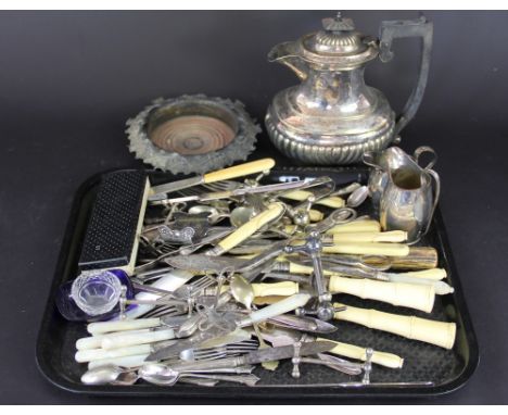 A 19th century plated bottle coaster, cast with fruiting vines; two plated milk jugs; ivory handled carving knife and fork, g
