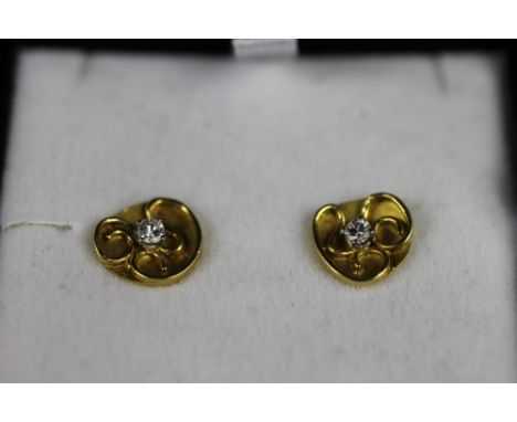 A pair of gold and diamond set stud earrings set in 18ct yellow gold, designed as a circular panel with wire work detail and 