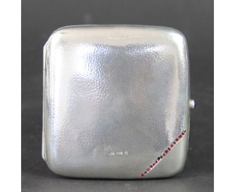 An Edwardian silver cigarette case, bearing import marks for Steinhart & Co, of rounded square form and with lightly hammered