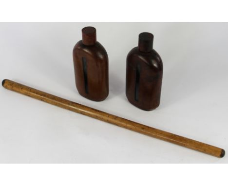 A pair of leather covered glass spirit decanters and screw covers, one marked B the other W; and a Malacca swagger stick, 20c