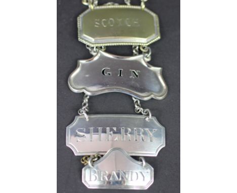 A George III silver decanter label 'Sherry' 'GL', London 1804, another 'Brandy' London 1806 and two silver plated examples 'S