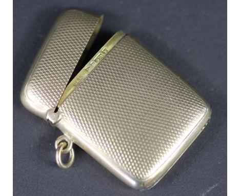 A 9ct yellow gold vesta case, Cohen & Charles, Chester 1921, with engine turned decoration throughout, weight 23gms 