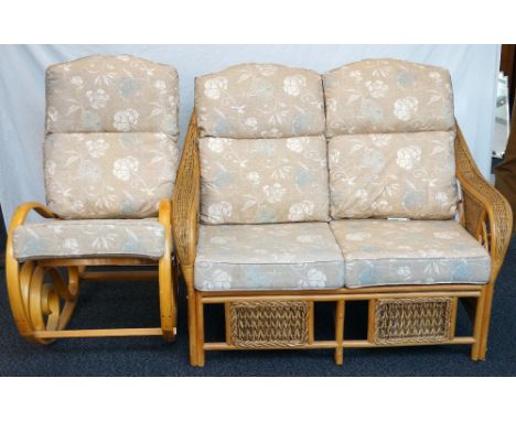 CONSERVATORY TWO SEAT SOFA
with shaped caned arms, together with a similar rocking chair, all with floral covered cushions