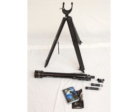 TASCO TELESCOPE
with an adjustable tripod stand and interchangeable eye pieces; together with a Phillips Planisphere and a bo