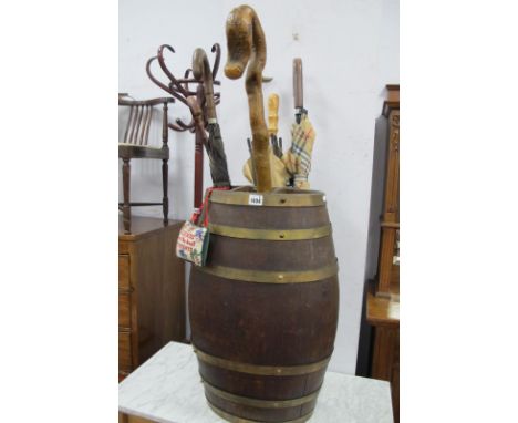 Brass Bound Oak Oval Shaped Barrel, as a stick stand, 61cm high, containing three umbrellas and three walking sticks.